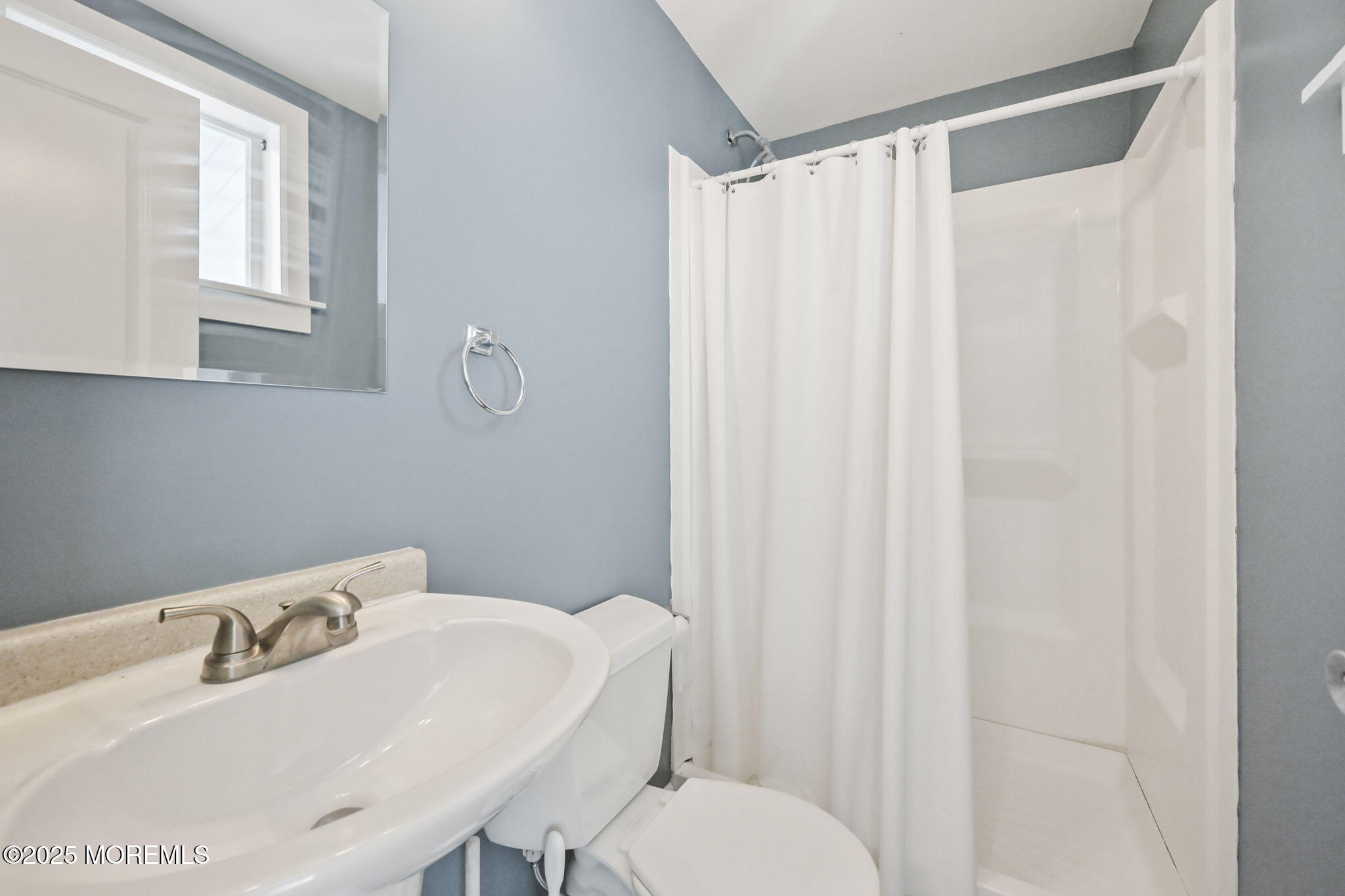 206 16th Avenue Belmar, NJ 07719 - Photo 15 of 20 a bathroom with a sink and a mirror