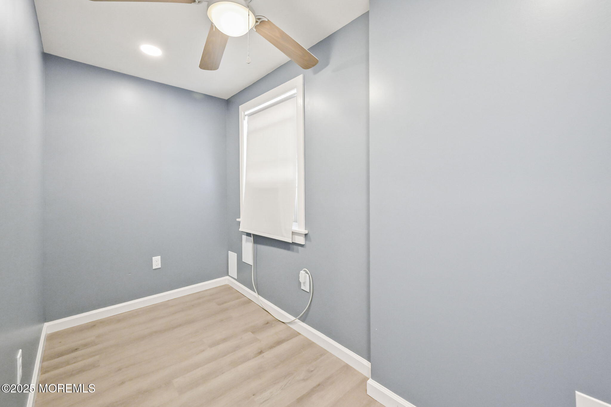 206 16th Avenue Belmar, NJ 07719 - Photo 16 of 20 a bedroom with a bed and a chandelier