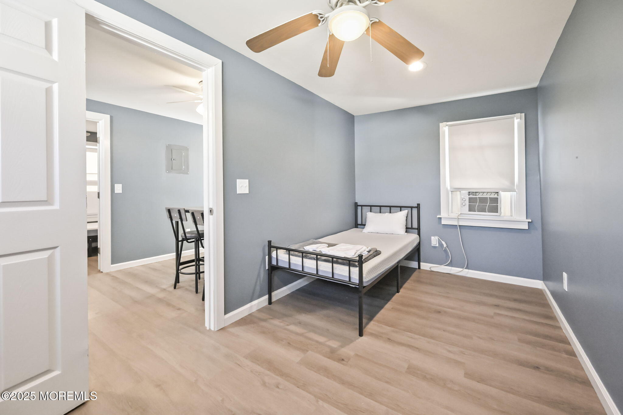 206 16th Avenue Belmar, NJ 07719 - Photo 17 of 20 a spacious bedroom with a bed and a chandelier