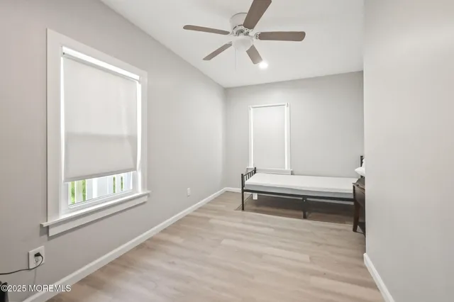 a bathroom with a window and a ceiling fan