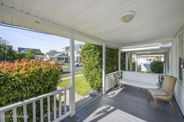 a view of a porch with furniture and garden