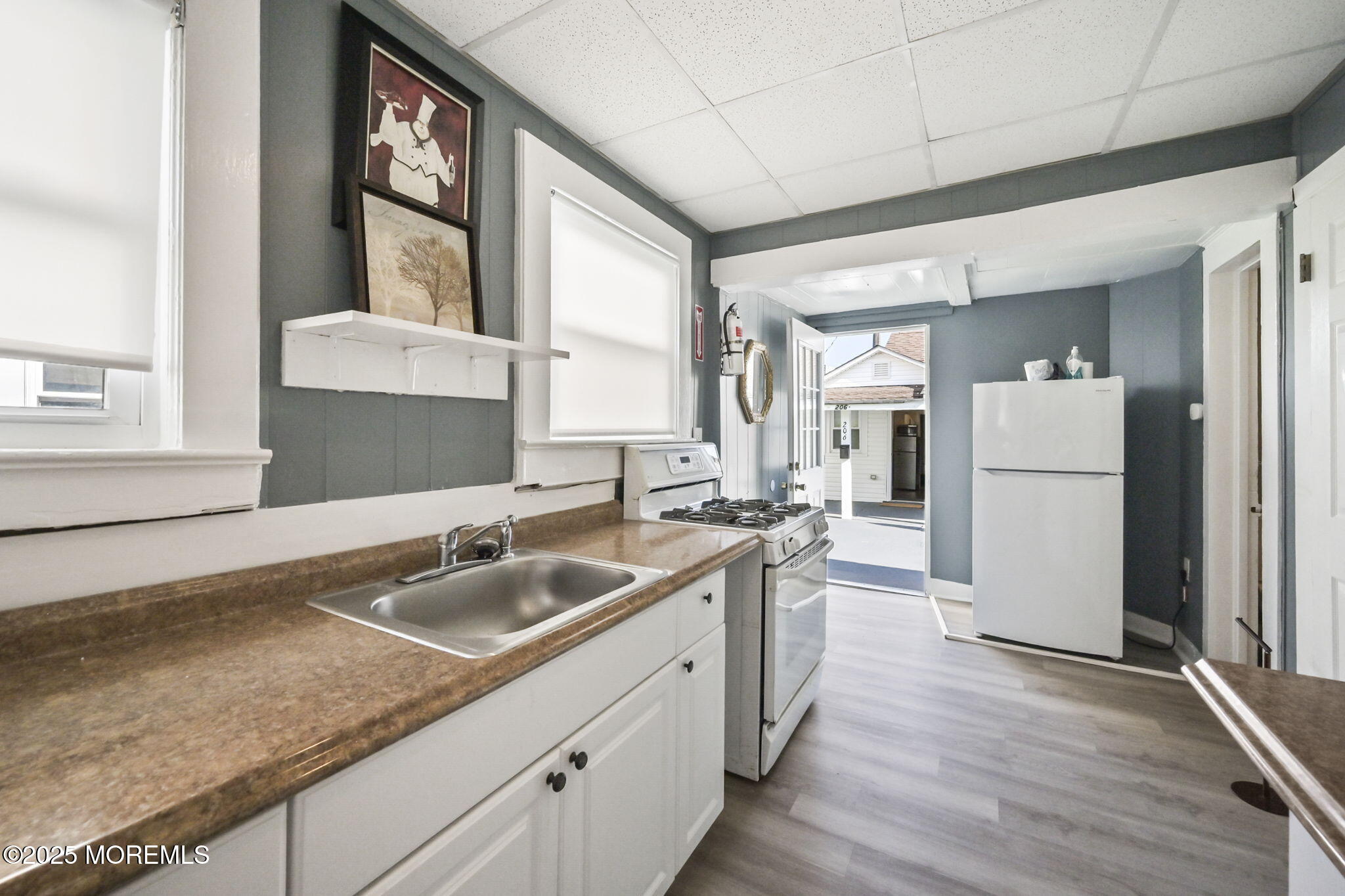 206 16th Avenue Belmar, NJ 07719 - Photo 8 of 20 a kitchen with a sink stove and refrigerator