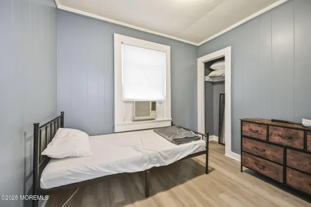 a bedroom with a bed and dresser