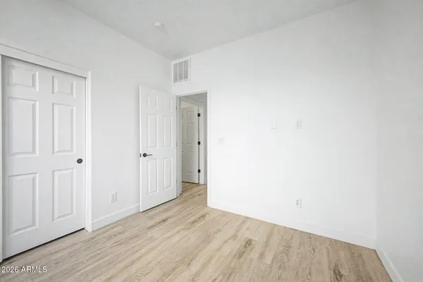an empty room with wooden floor