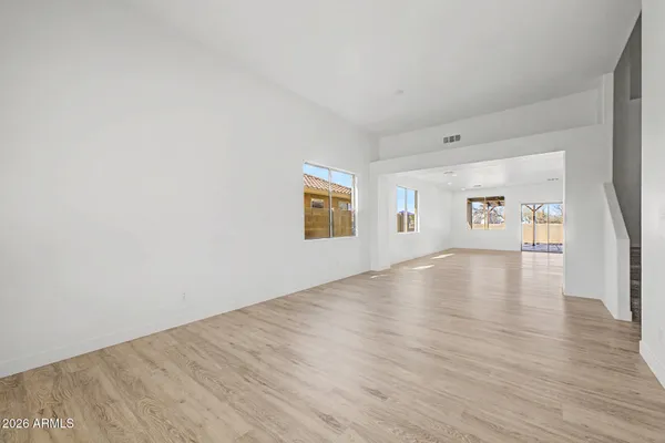 a view of a livingroom with wooden floor and window