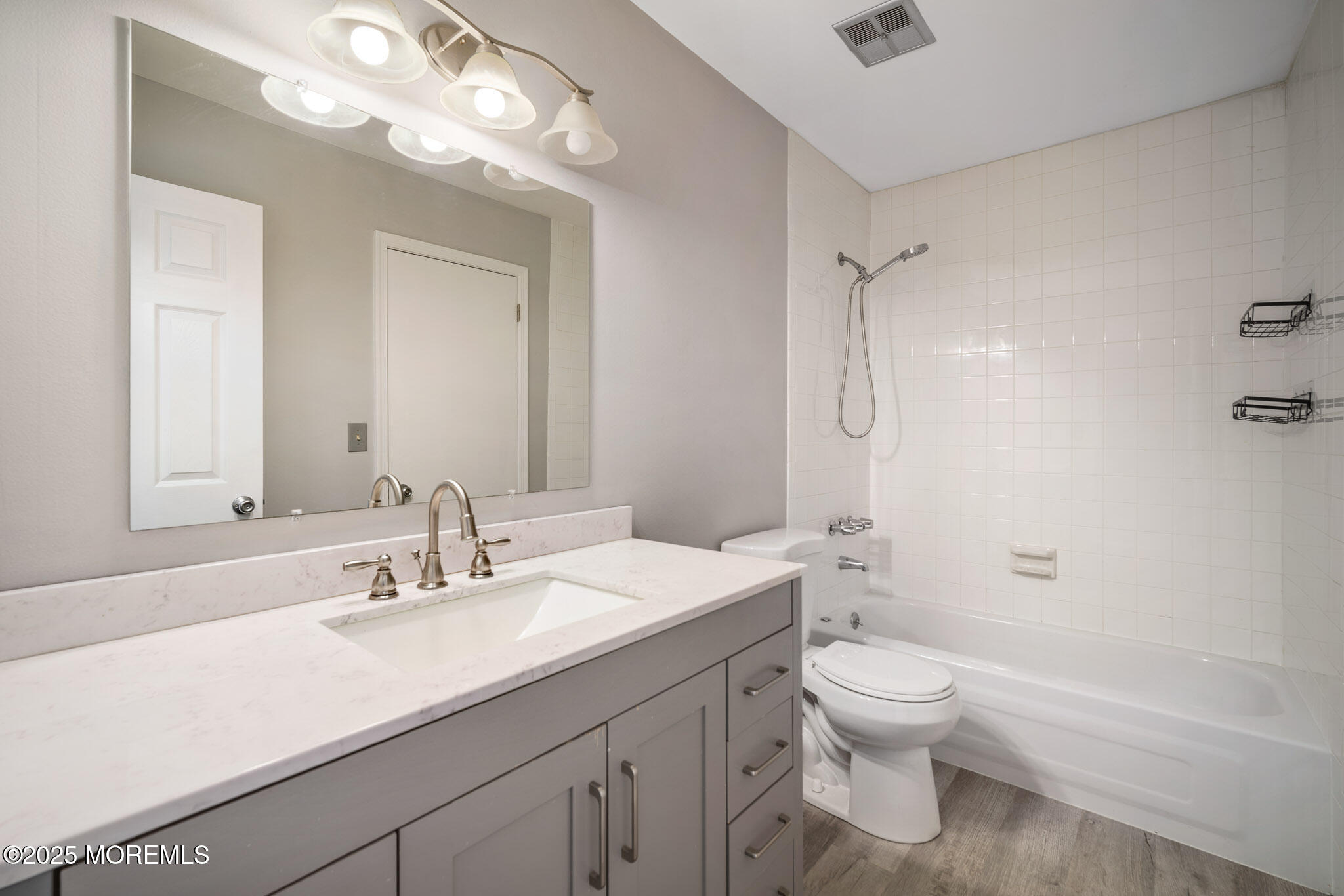 12 6th Street Barnegat, NJ 08005 - Photo 13 of 31 a bathroom with a sink a toilet and a large mirror