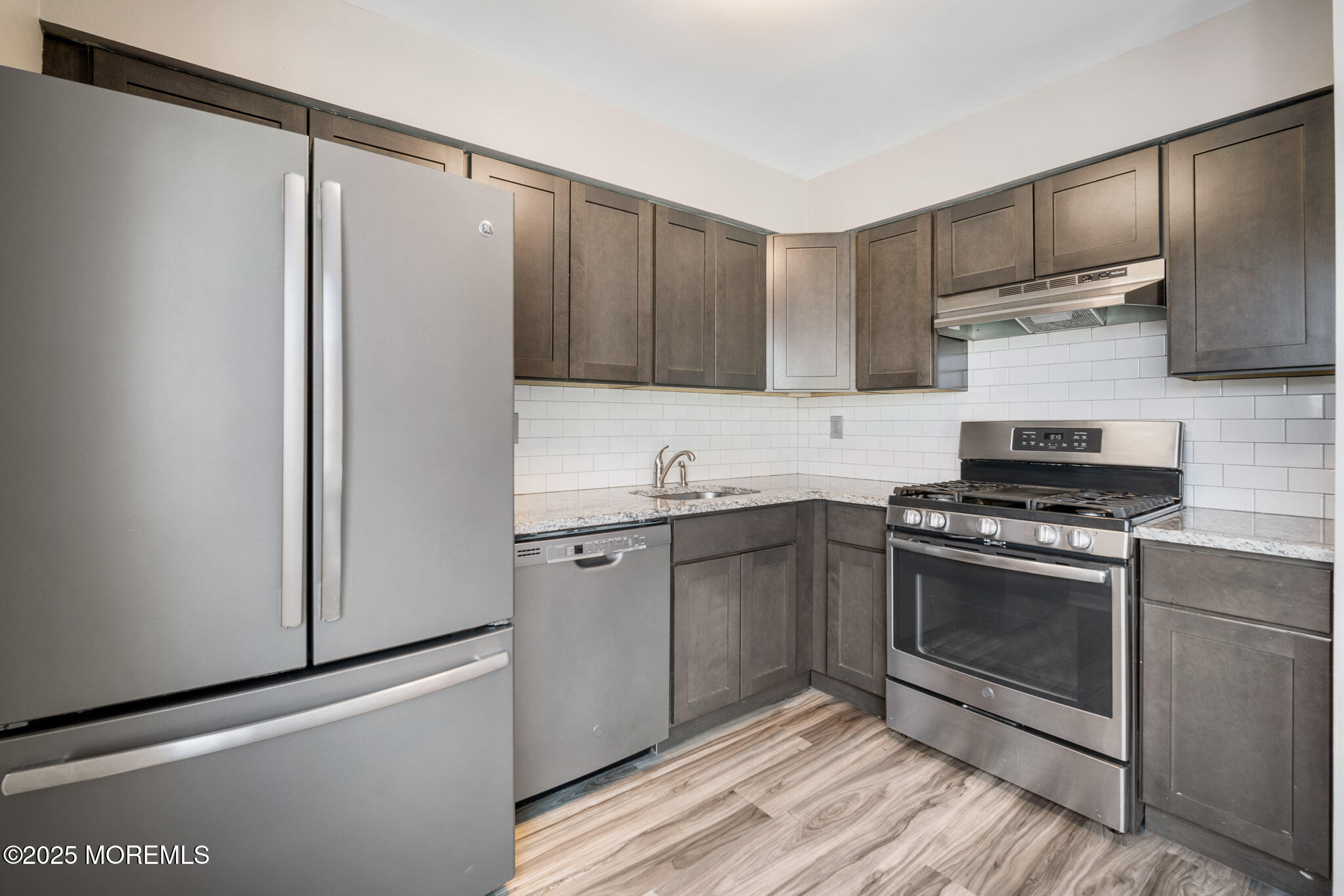 12 6th Street Barnegat, NJ 08005 - Photo 5 of 31 a kitchen with stainless steel appliances granite countertop a stove a sink and a refrigerator