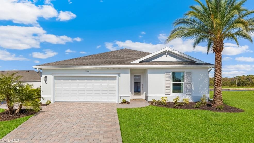 3913 16th Street West Lehigh Acres, FL 33971 - Photo 1 of 15 Model home. Ranch-style home with stucco siding, a garage, and decorative driveway