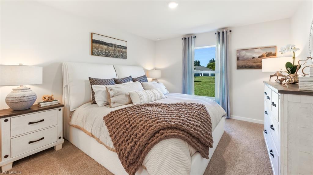 3913 16th Street West Lehigh Acres, FL 33971 - Photo 11 of 15 Model home. Bedroom featuring light colored carpet and baseboards