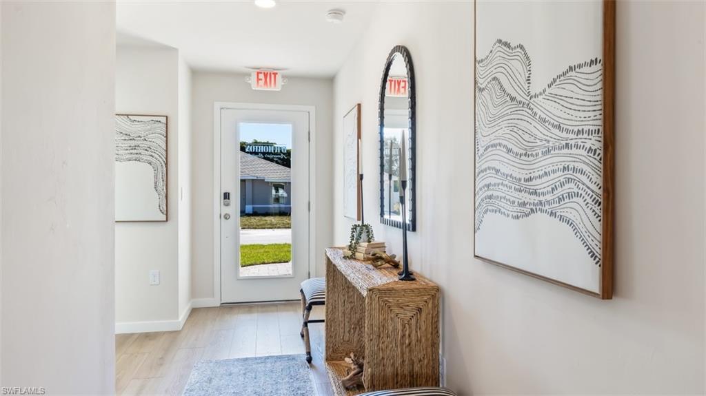 3913 16th Street West Lehigh Acres, FL 33971 - Photo 2 of 15 Model home. Doorway with wood finished floors and baseboards
