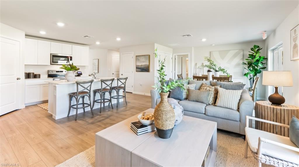 3913 16th Street West Lehigh Acres, FL 33971 - Photo 5 of 15 Model home. Living area featuring light wood-style flooring and recessed lighting