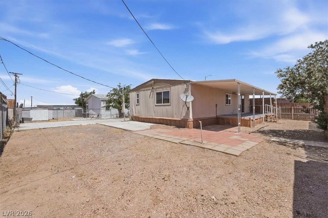 283 Aztec Lane Henderson, NV 89015 - Photo 20 of 21 A manufactured home with a spacious covered deck and adjacent paved patio.