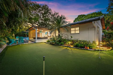 a front view of a house with a garden