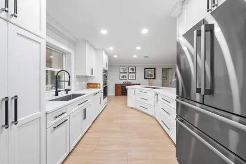 a large kitchen with cabinets and stainless steel appliances