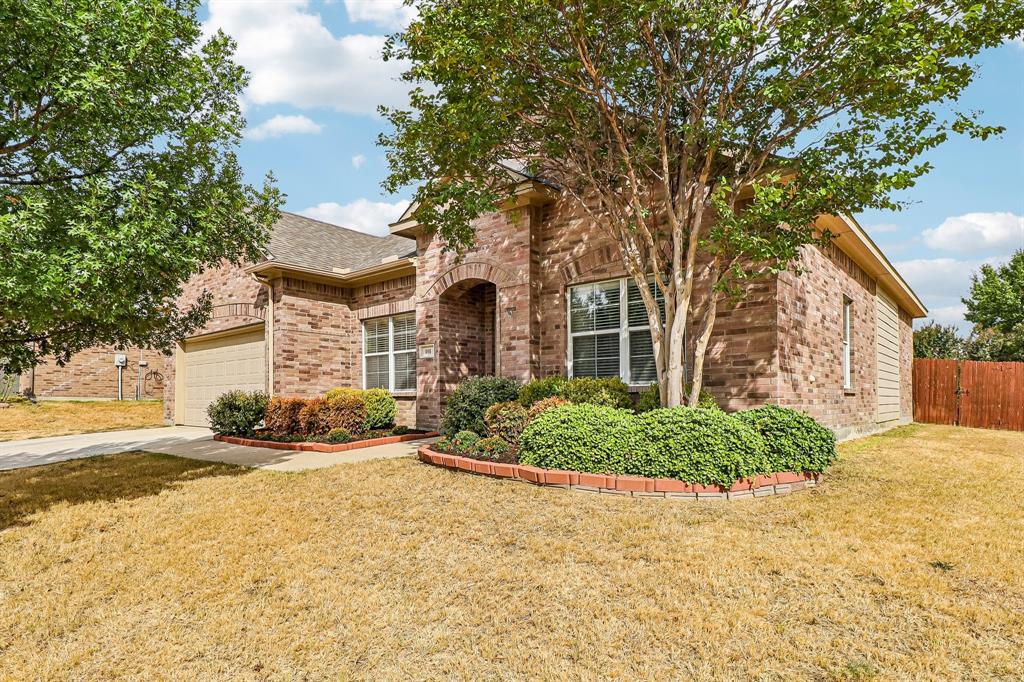 101 Ravinia Court Oak Point, TX 75068 - Photo 2 of 23 Brick facade with an arched entry, two-car garage, and fenced backyard
