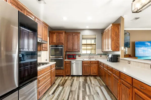 a kitchen with a sink stove microwave and refrigerator