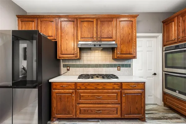 a kitchen with granite countertop cabinets stainless steel appliances and a window