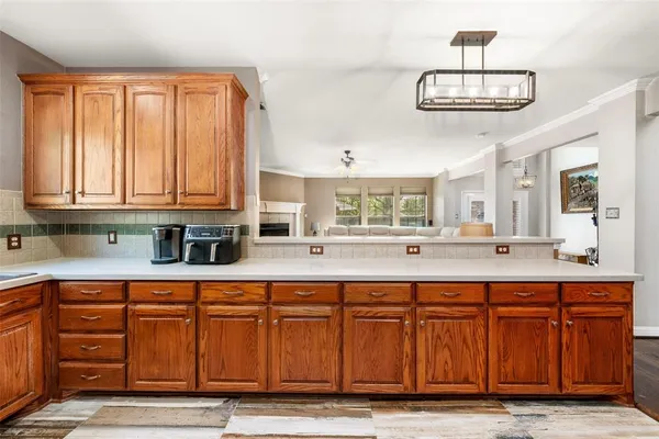 a spacious kitchen with stainless steel appliances granite countertop a stove and a sink