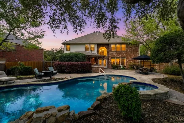 a front view of a house with swimming pool yard and outdoor seating