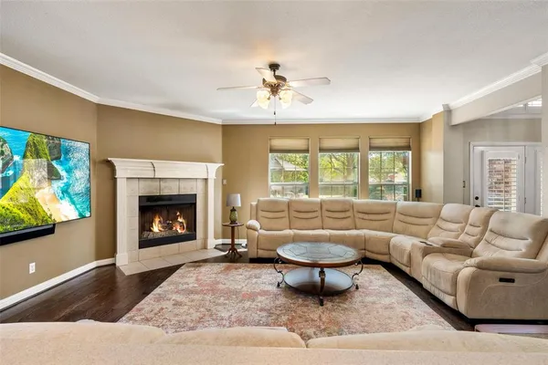 a living room with furniture a fireplace and a flat screen tv
