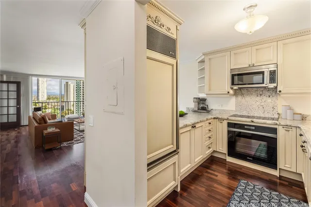 a kitchen with granite countertop a stove top oven a sink dishwasher a dining table and chairs with wooden floor