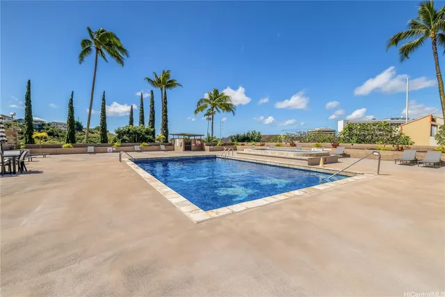 a view of a swimming pool with a lounge chairs