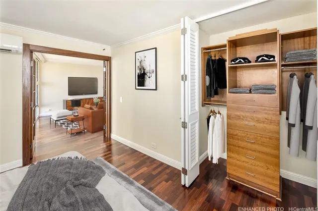 a view of a livingroom with wooden floor and furniture