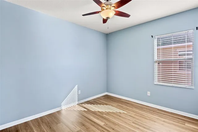 a view of a room with a ceiling fan and a window