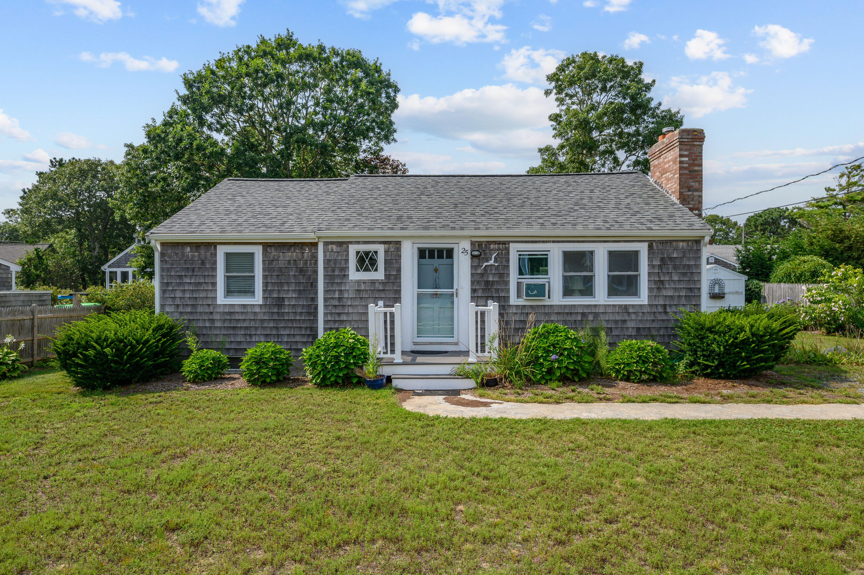 25 Pine Cone Drive West Yarmouth, MA 02673 - Photo 1 of 34 a front view of a house with a yard