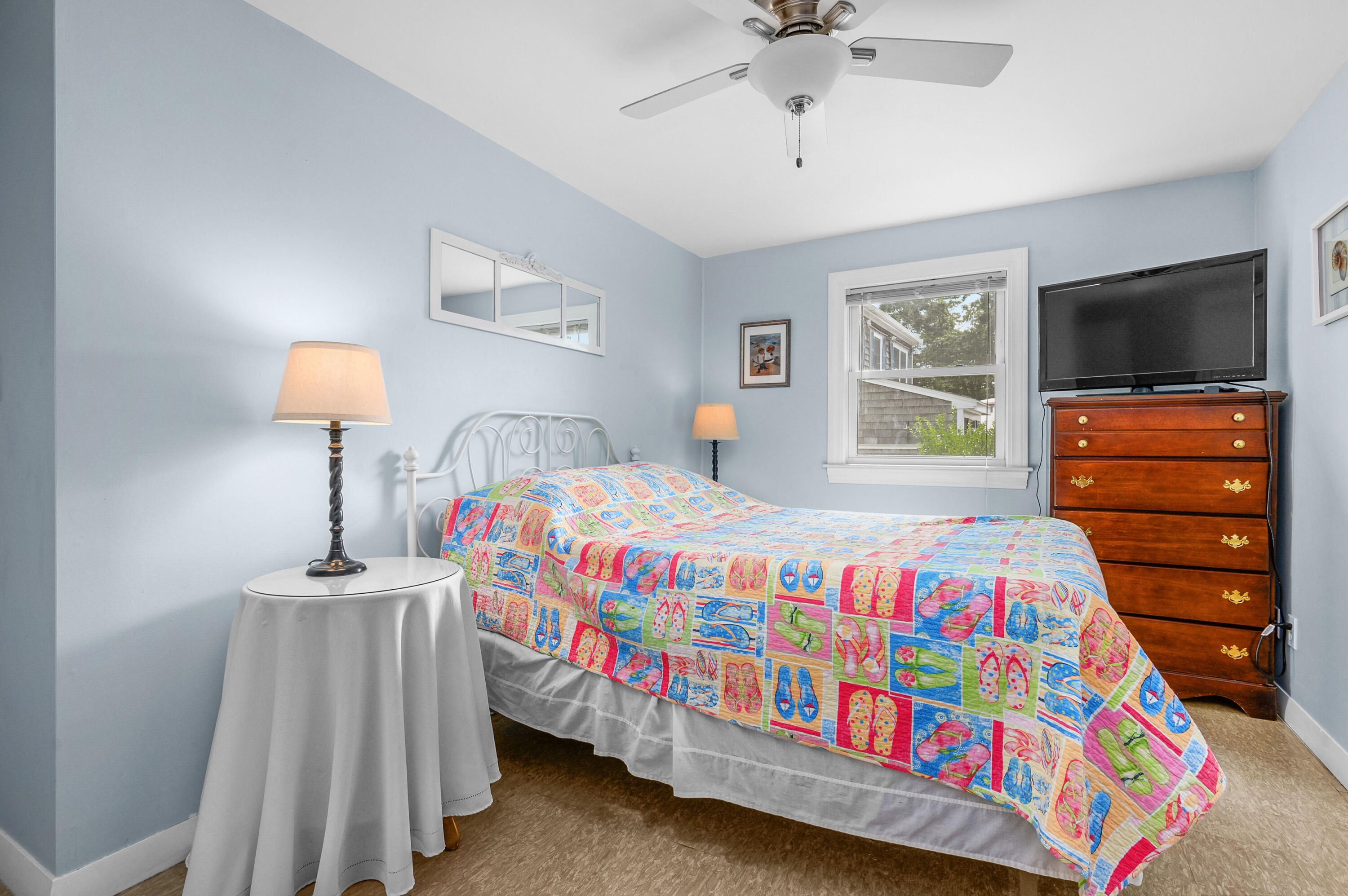 25 Pine Cone Drive West Yarmouth, MA 02673 - Photo 18 of 34 a bedroom with a bed and a flat tv screen on dresser
