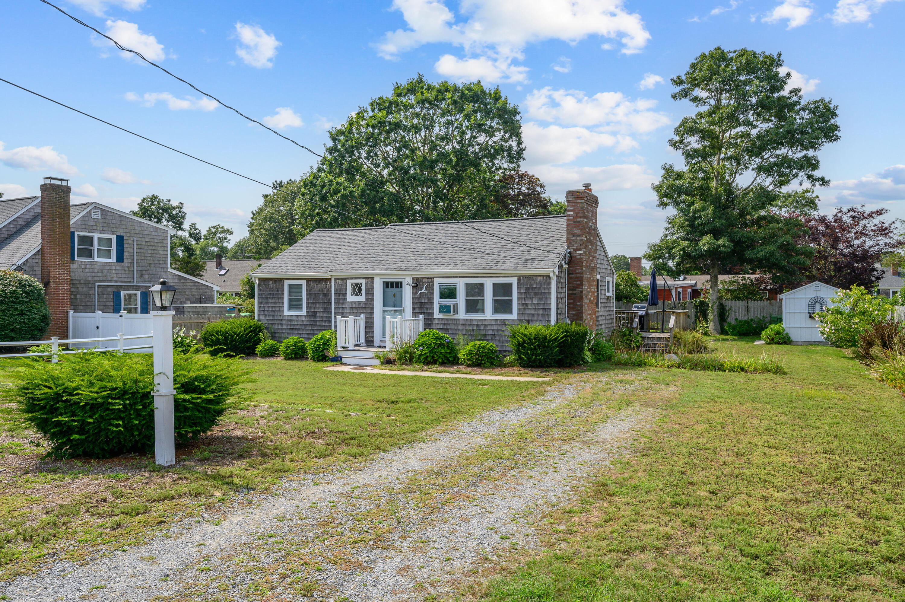 25 Pine Cone Drive West Yarmouth, MA 02673 - Photo 2 of 34 a front view of a house with garden