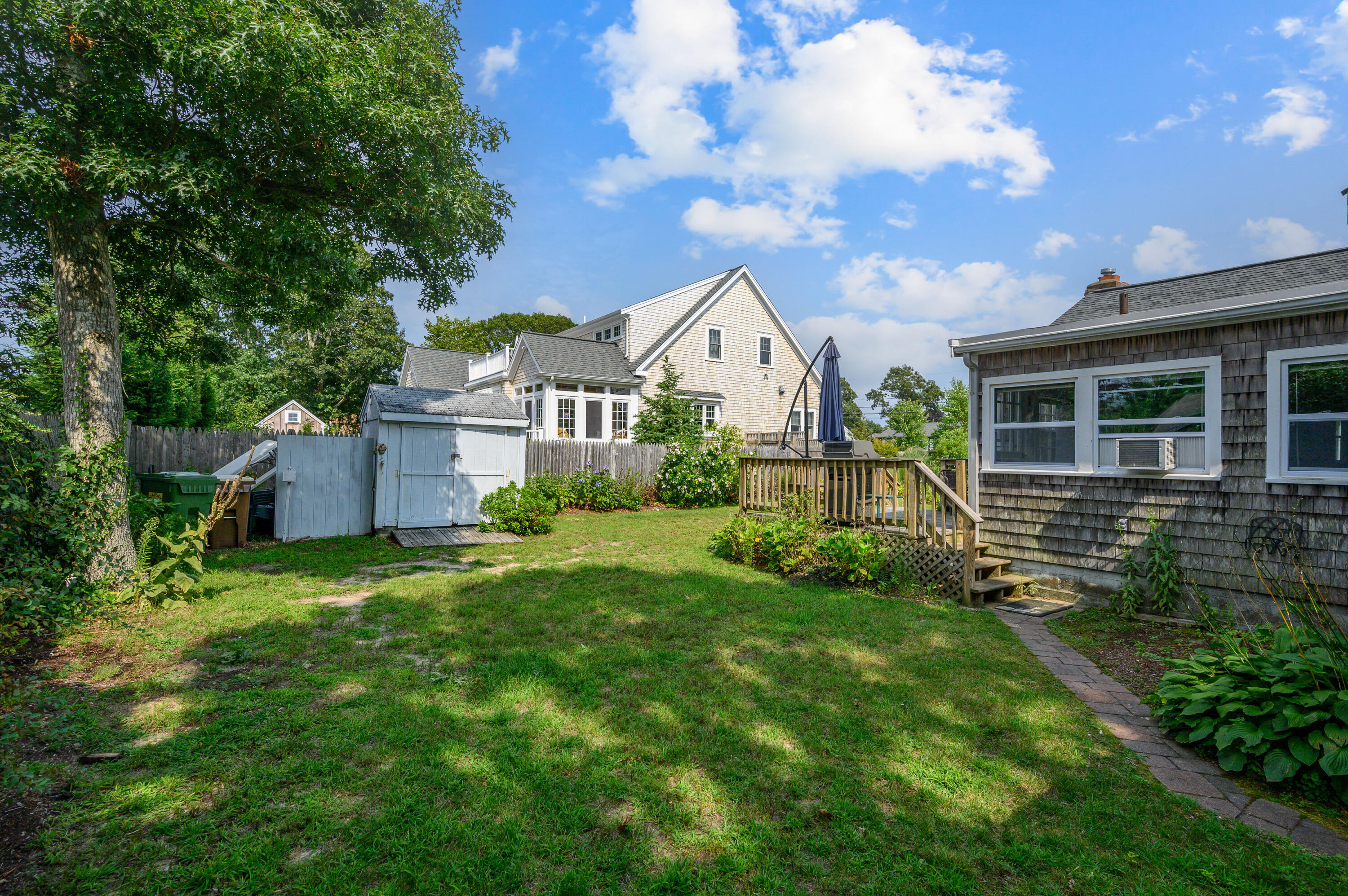 25 Pine Cone Drive West Yarmouth, MA 02673 - Photo 23 of 34 a view of a house with a big yard plants and large trees