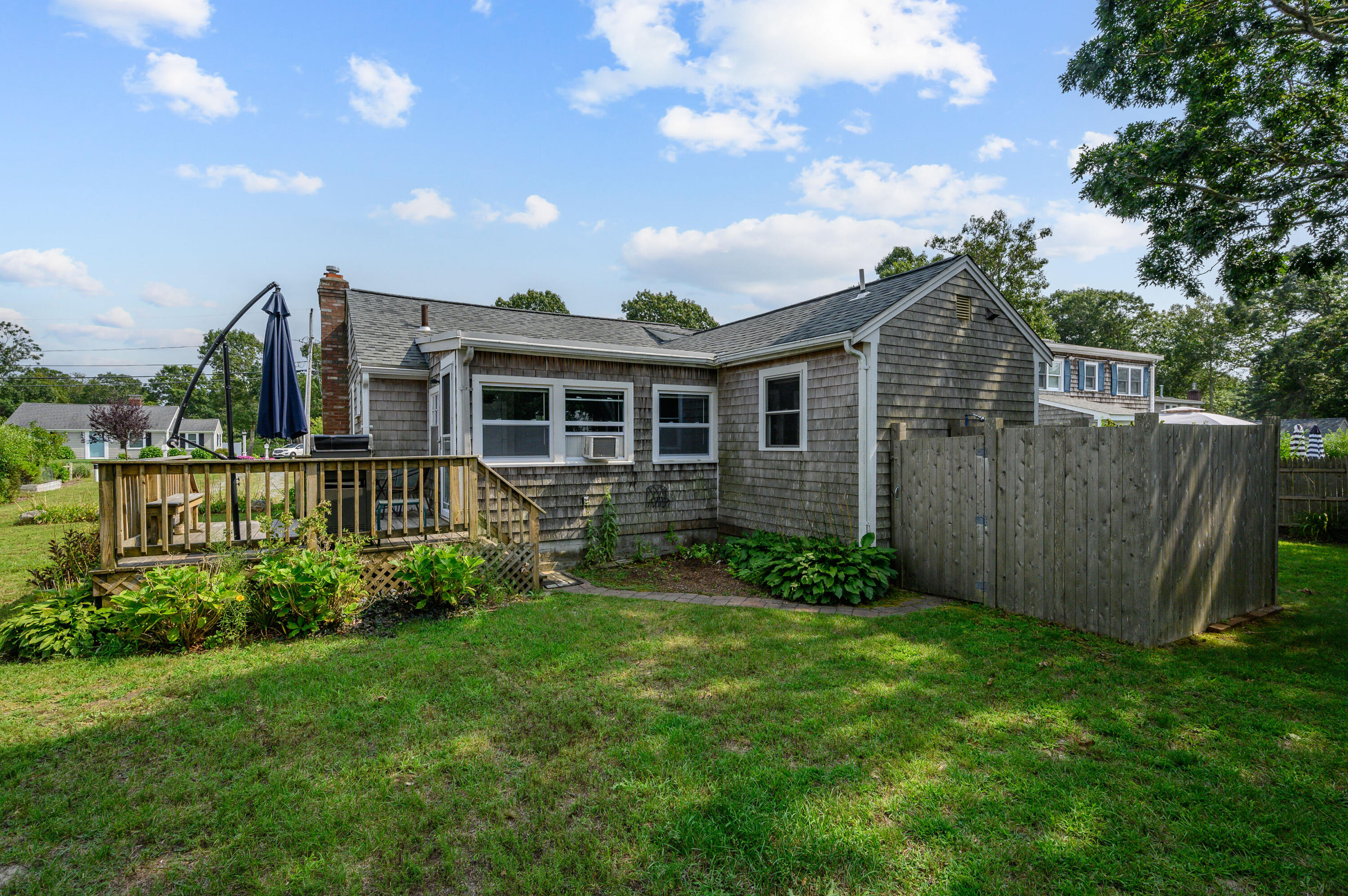 25 Pine Cone Drive West Yarmouth, MA 02673 - Photo 24 of 34 a view of a house with brick walls and a yard with plants