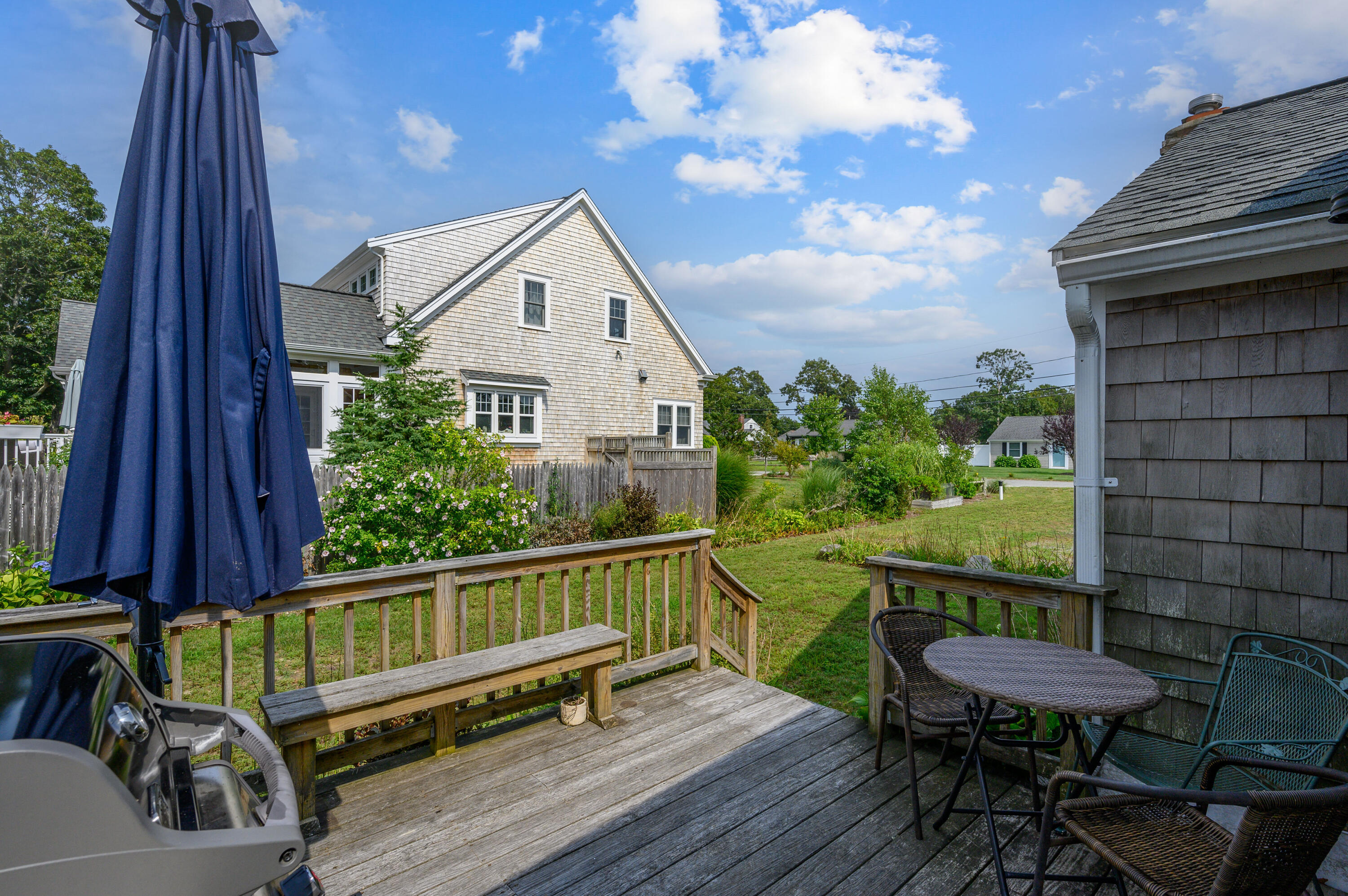 25 Pine Cone Drive West Yarmouth, MA 02673 - Photo 27 of 34 a view of a deck with a table and chairs