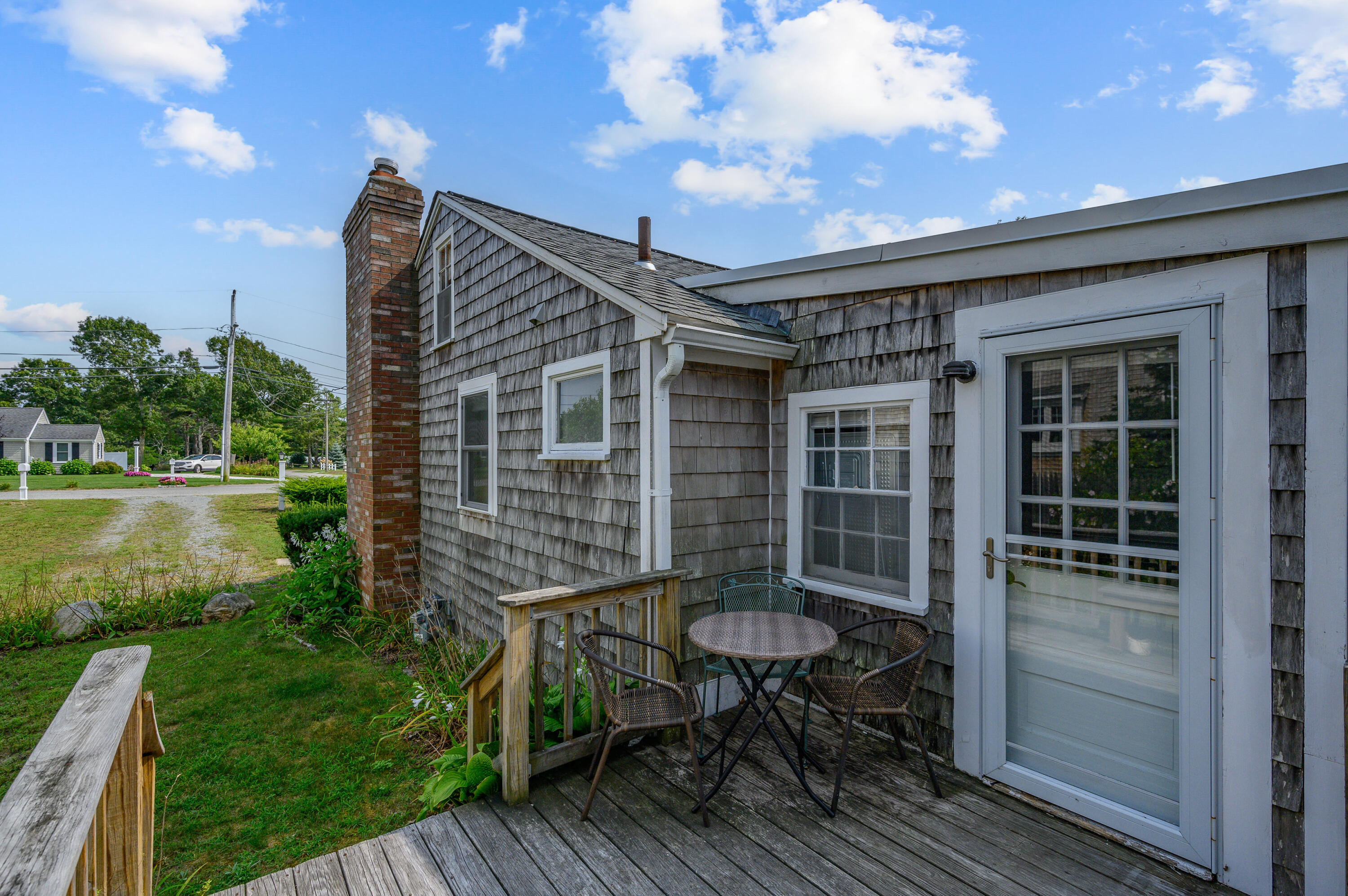 25 Pine Cone Drive West Yarmouth, MA 02673 - Photo 28 of 34 a backyard of a house with table and chairs