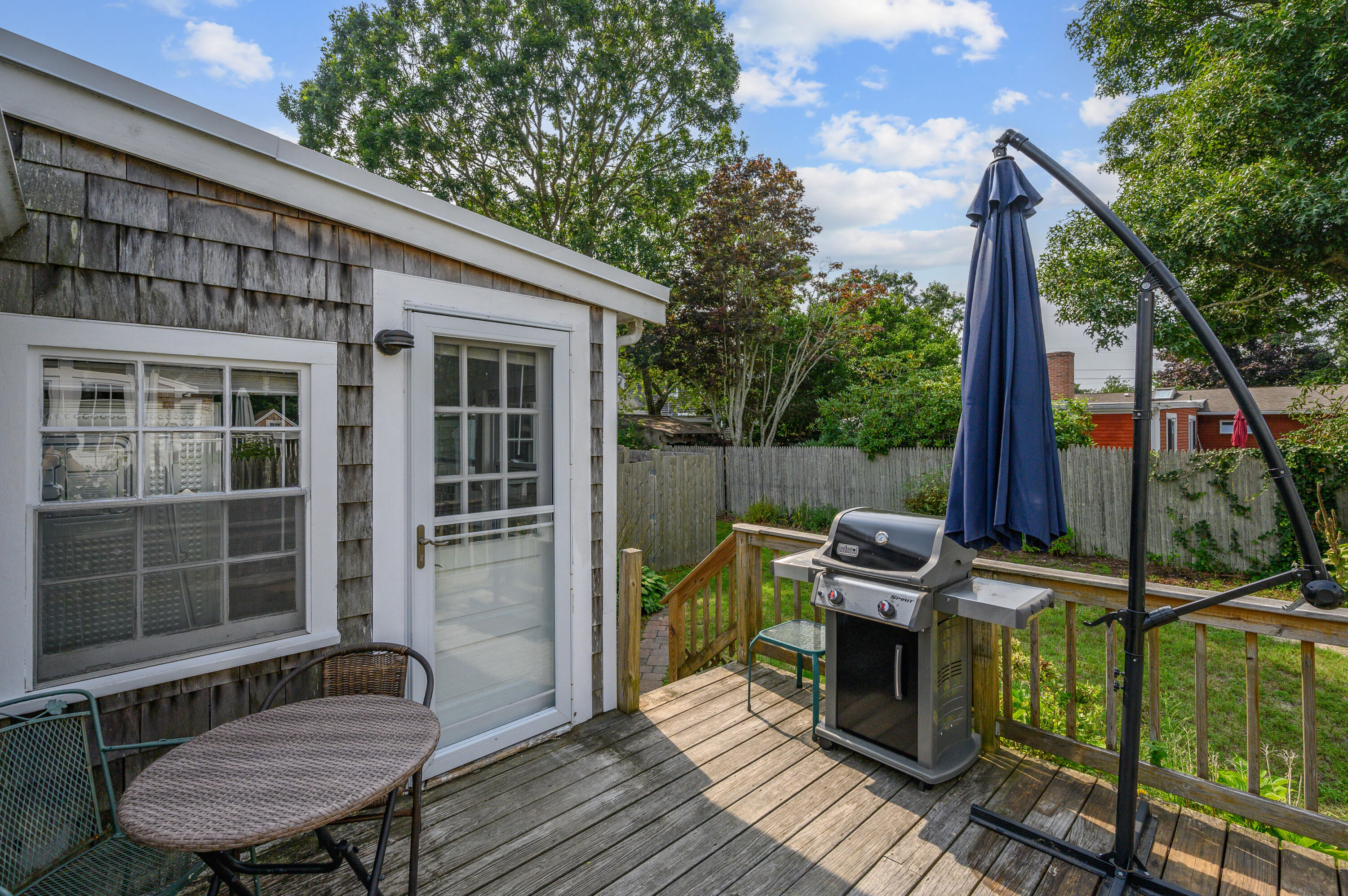 25 Pine Cone Drive West Yarmouth, MA 02673 - Photo 29 of 34 a view of a deck with wooden floor and iron fence