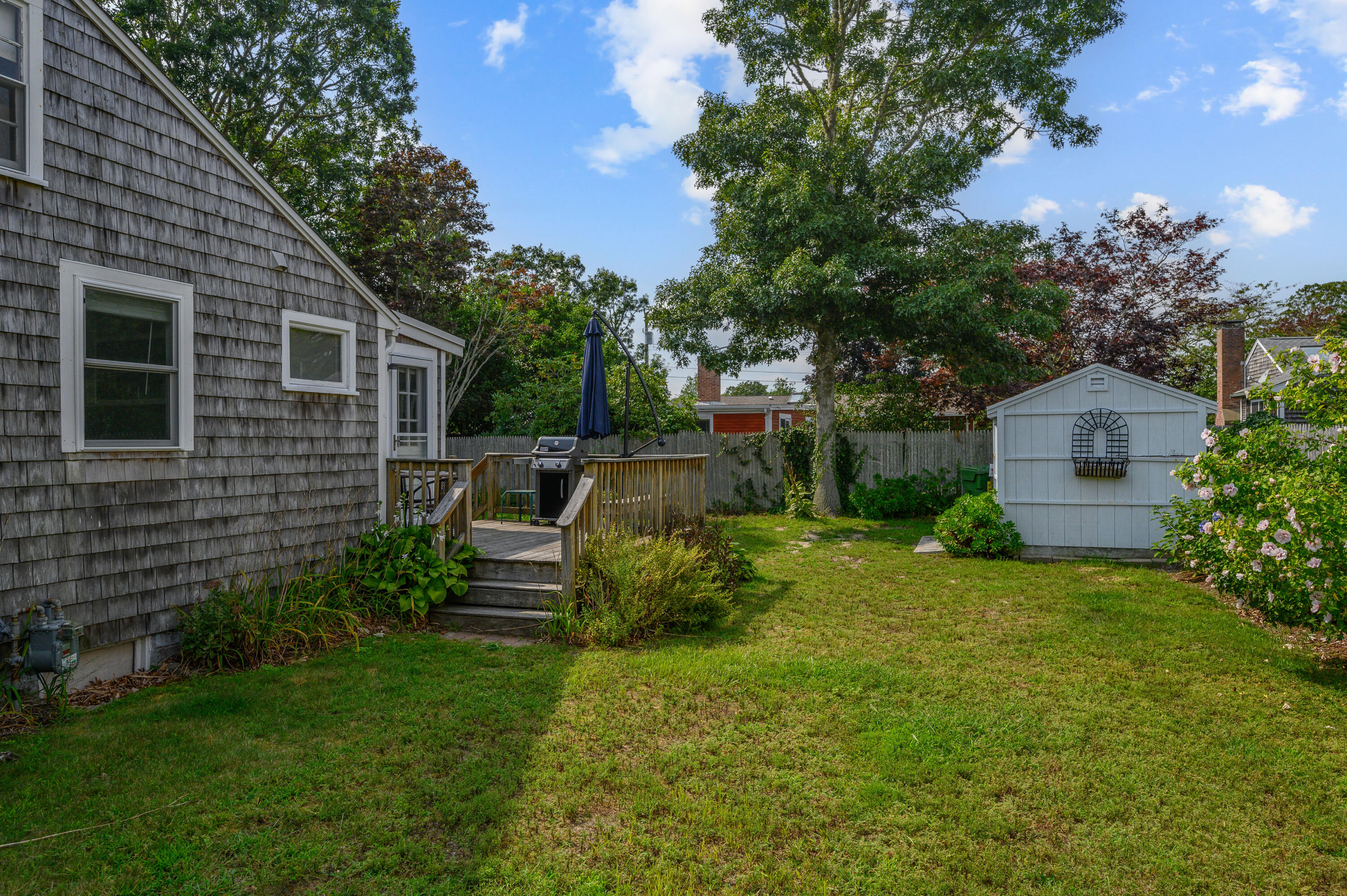 25 Pine Cone Drive West Yarmouth, MA 02673 - Photo 30 of 34 a view of a house with backyard sitting area and garden