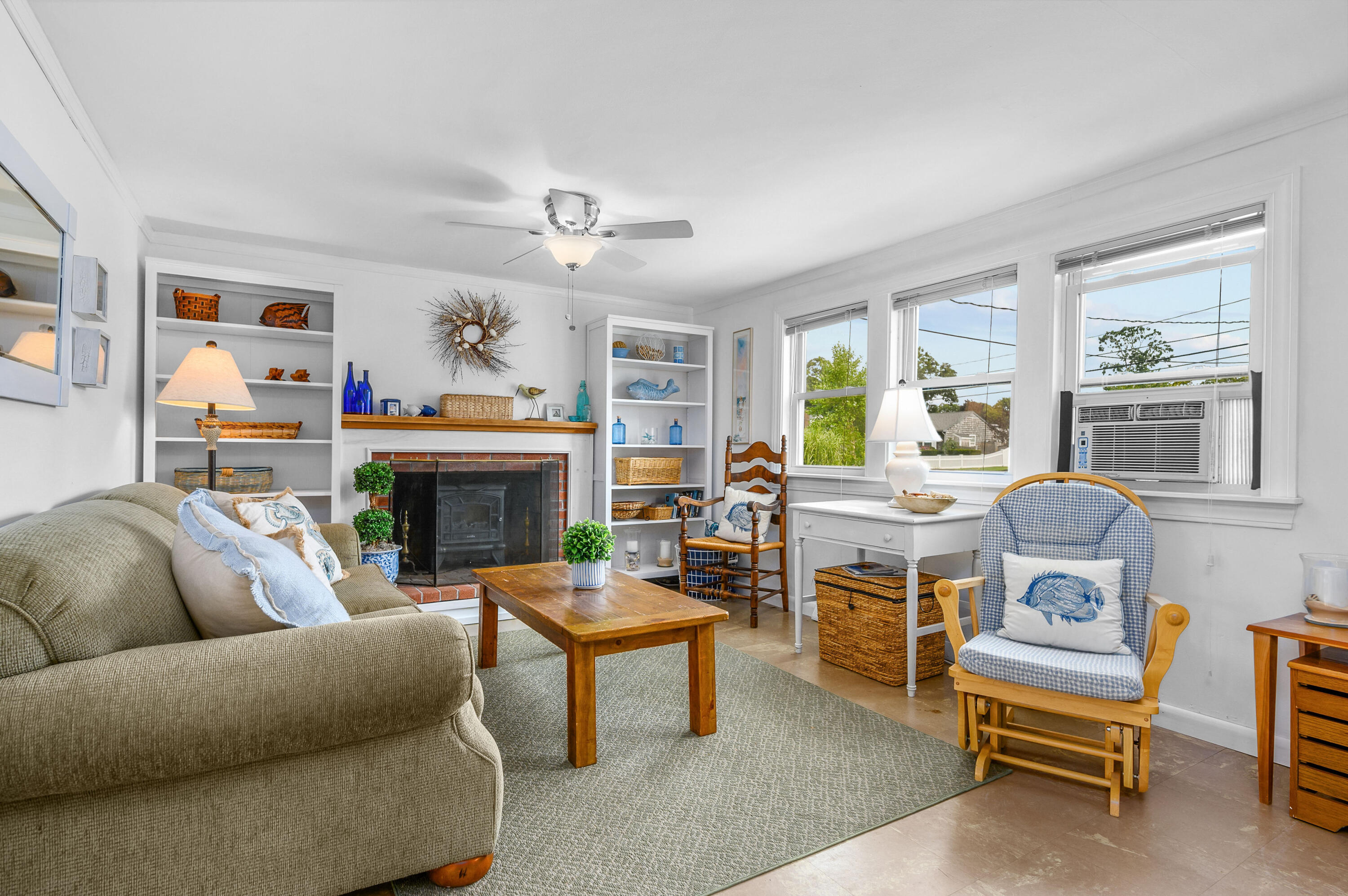25 Pine Cone Drive West Yarmouth, MA 02673 - Photo 5 of 34 a living room with furniture a fireplace and a window