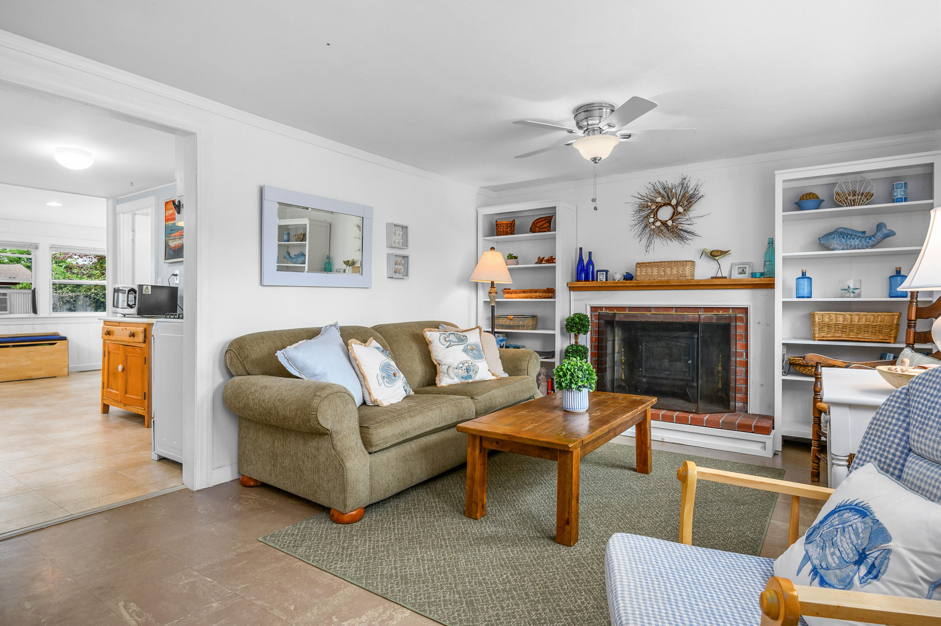 25 Pine Cone Drive West Yarmouth, MA 02673 - Photo 6 of 34 a living room with furniture and a fireplace