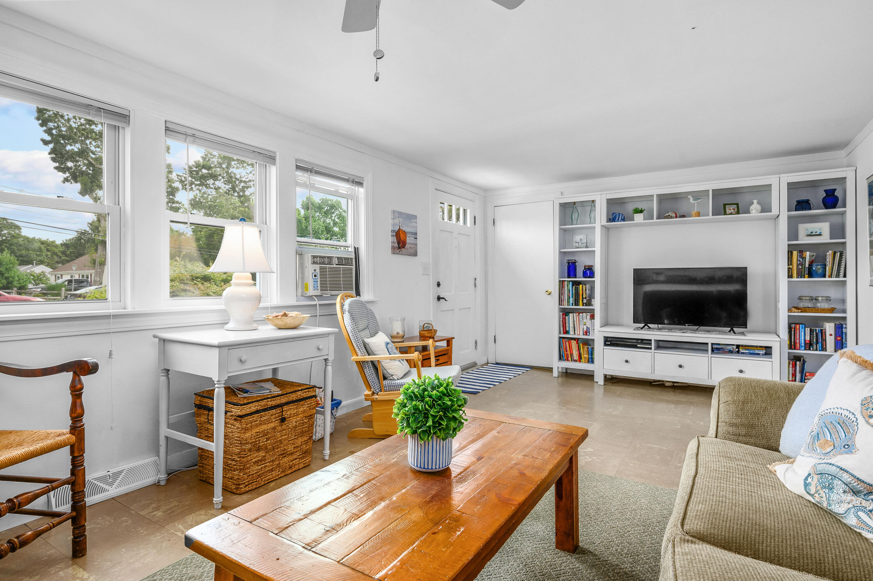 25 Pine Cone Drive West Yarmouth, MA 02673 - Photo 7 of 34 a living room with furniture a flat screen tv and a large window