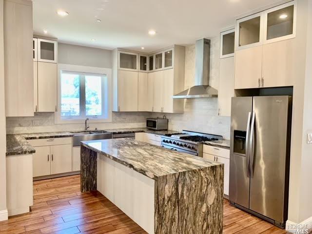 40 Villa Avenue San Rafael, CA 94901 - Photo 9 of 47 a kitchen with stainless steel appliances granite countertop a stove a refrigerator a sink dishwasher a refrigerator white cabinets and wooden floor next to a window