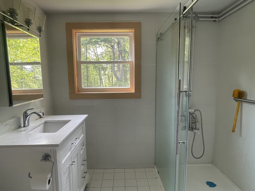 32 Hollow Road Wales, MA 01081 - Photo 10 of 35 a bathroom with a sink a vanity and a shower