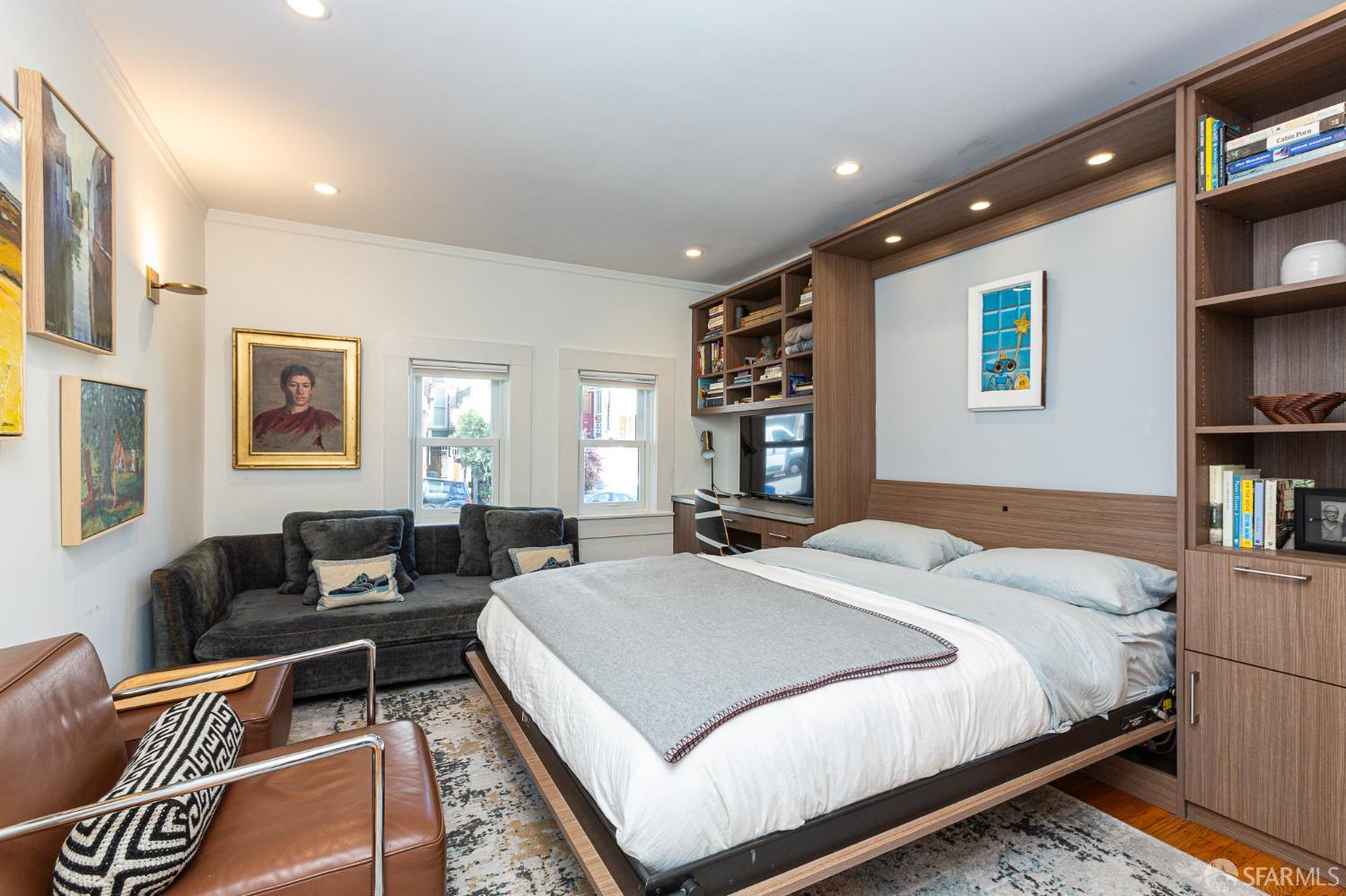 863 Haight Street, Unit 5 San Francisco, CA 94117 - Photo 4 of 16 a spacious bedroom with a bed a couch and a bookshelf