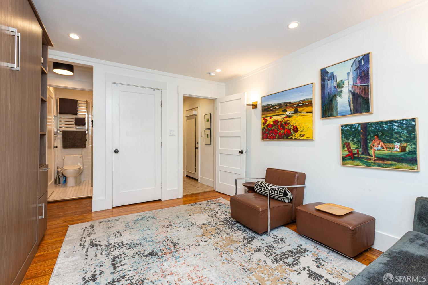 863 Haight Street, Unit 5 San Francisco, CA 94117 - Photo 5 of 16 a living room with furniture and a flat screen tv