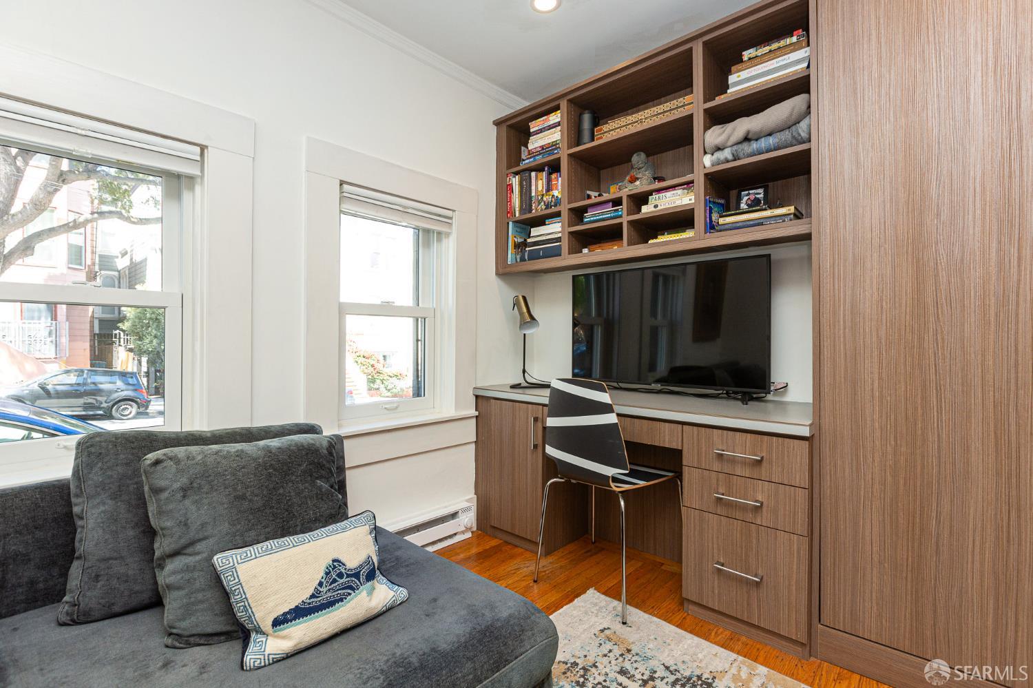 863 Haight Street, Unit 5 San Francisco, CA 94117 - Photo 6 of 16 a living room with furniture and a flat screen tv