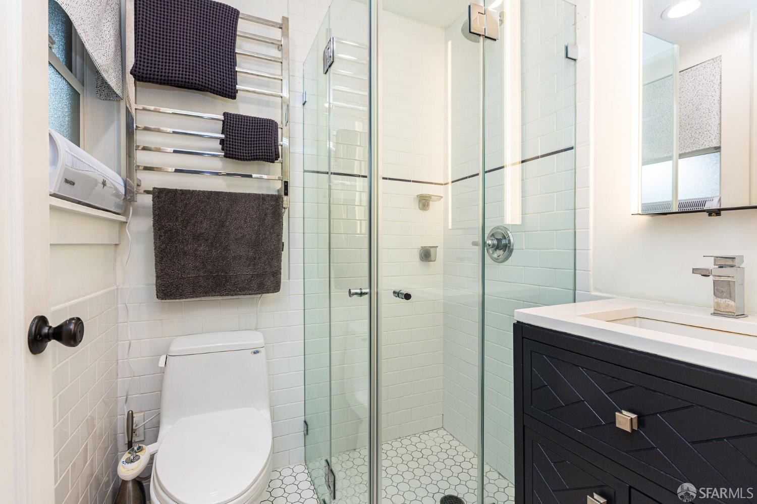 863 Haight Street, Unit 5 San Francisco, CA 94117 - Photo 8 of 16 a bathroom with a sink a toilet and shower