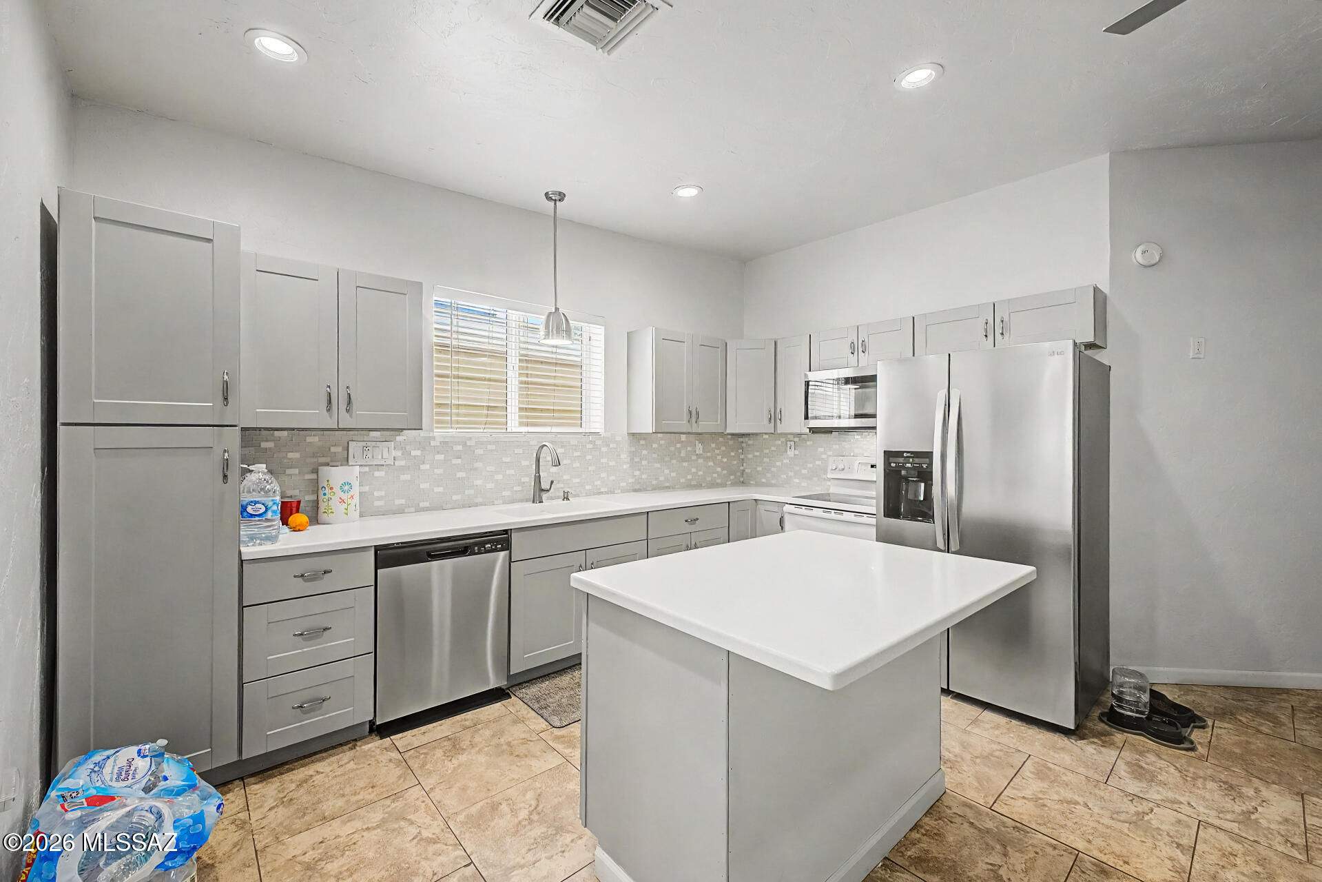 4231 East Pinal Street Tucson, AZ 85739 - Photo 29 of 36 a kitchen with granite countertop a sink appliances and cabinets