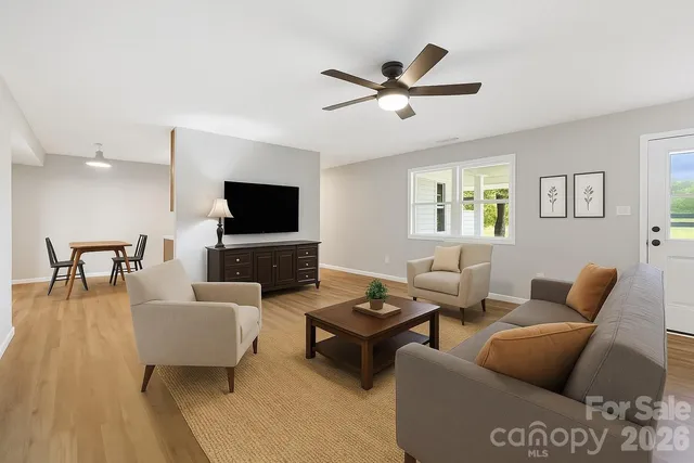 a living room with furniture and a flat screen tv