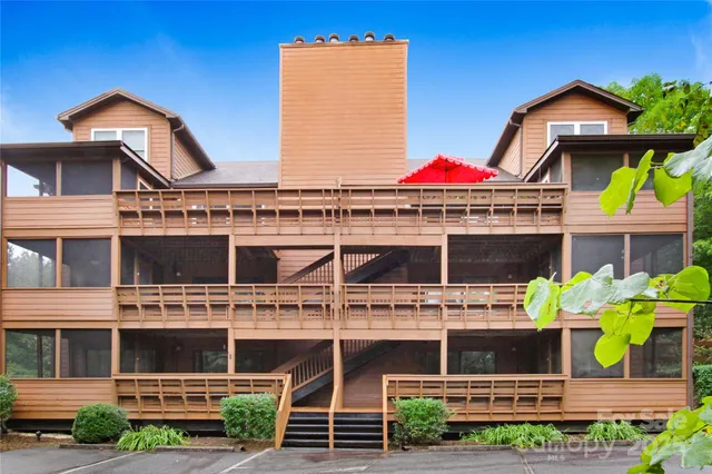 a view of a house with a small window and potted plants
