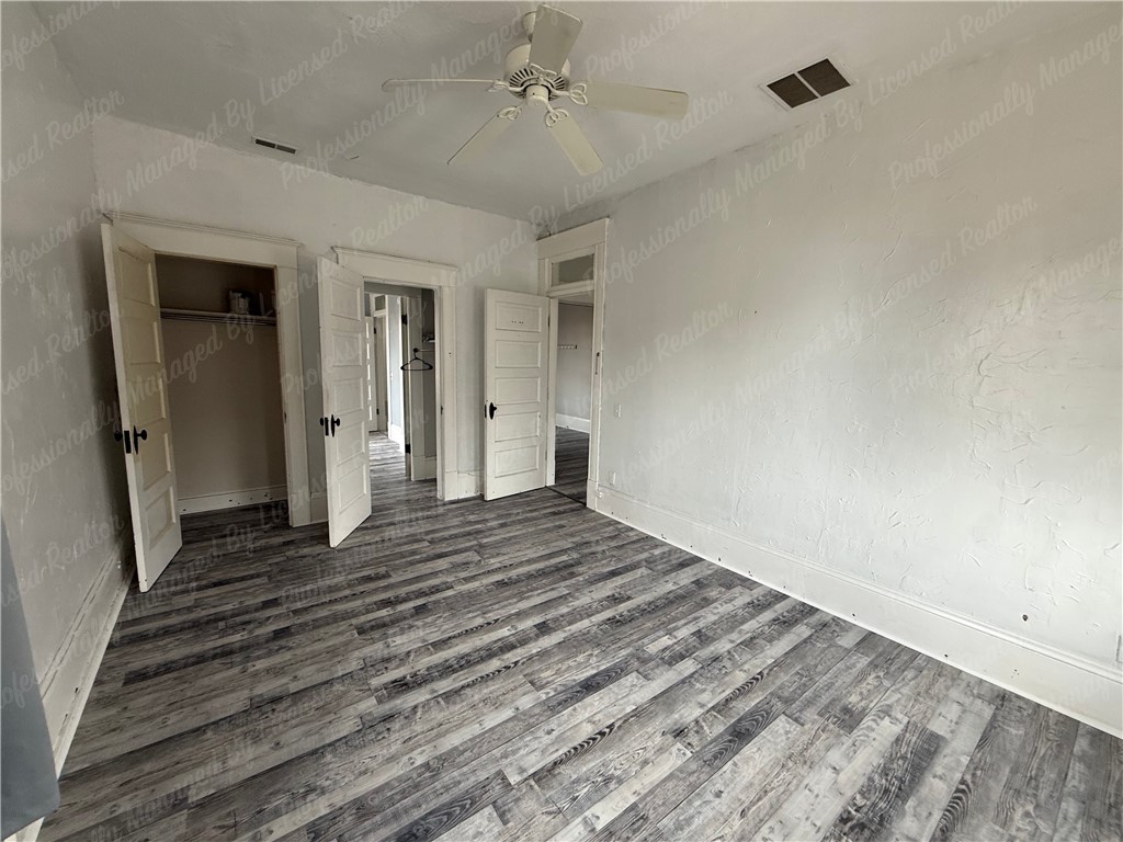44 West High Street, Unit D Springfield, OH 45502 - Photo 11 of 25 This spacious room features durable flooring, offering a versatile living space.